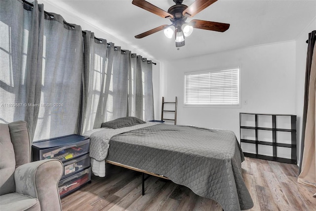 bedroom with hardwood / wood-style floors and ceiling fan