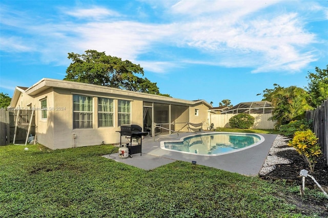 back of property featuring a patio and a fenced in pool