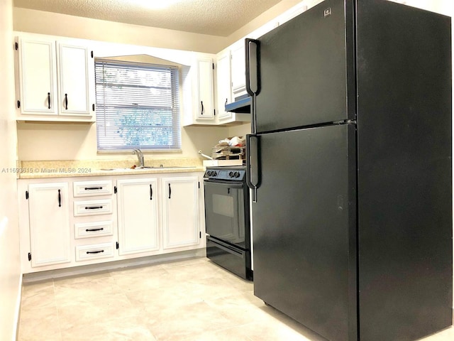 kitchen featuring black appliances, white cabinetry, ventilation hood, and a textured ceiling