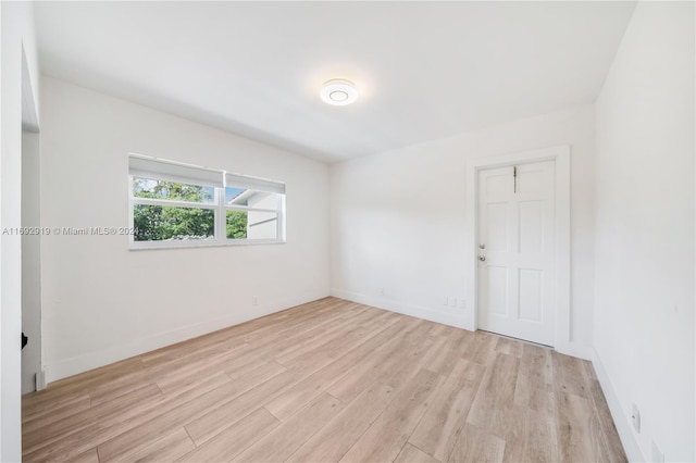 unfurnished room with light wood-type flooring