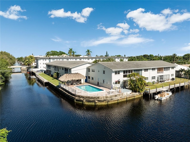 back of property featuring a water view