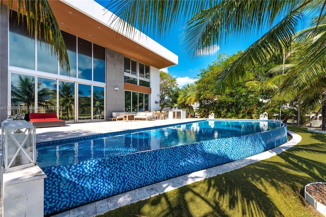 view of swimming pool featuring an outdoor living space and a patio