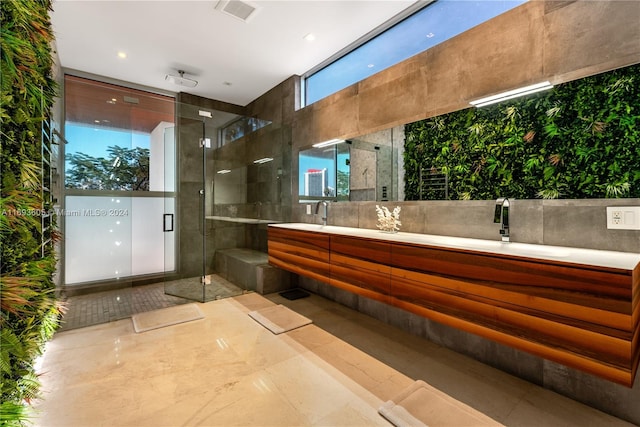 bathroom with tile patterned flooring, vanity, and an enclosed shower