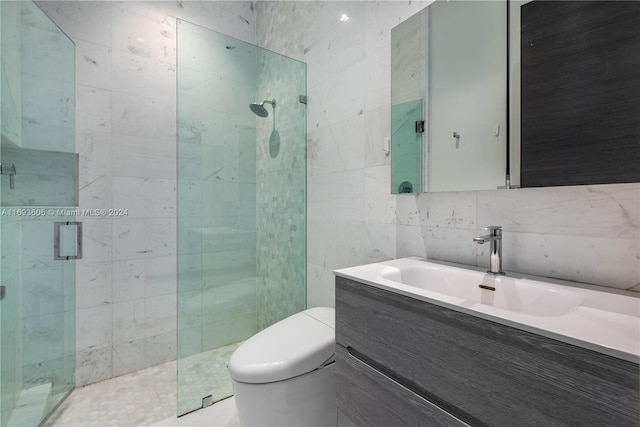 bathroom featuring toilet, vanity, tile walls, and walk in shower