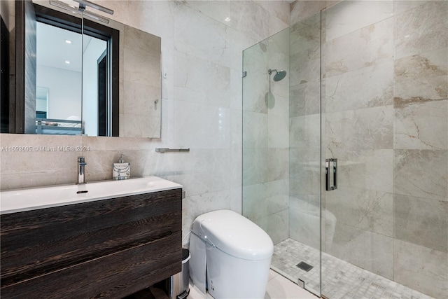 bathroom featuring backsplash, toilet, vanity, a shower with shower door, and tile walls