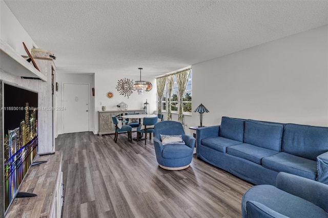 living room with wood-type flooring and a textured ceiling