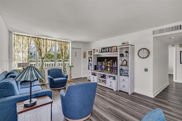 living room with hardwood / wood-style floors and a textured ceiling