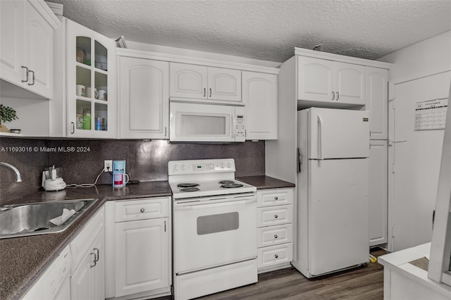 kitchen with white cabinets, sink, white appliances, and dark wood-type flooring