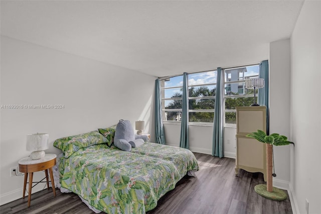 bedroom with dark hardwood / wood-style floors