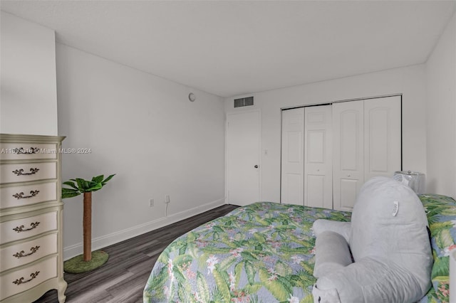 bedroom featuring dark hardwood / wood-style floors and a closet