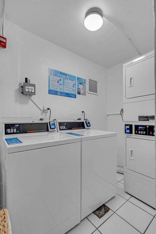 laundry area featuring light tile patterned floors, stacked washer and dryer, and independent washer and dryer