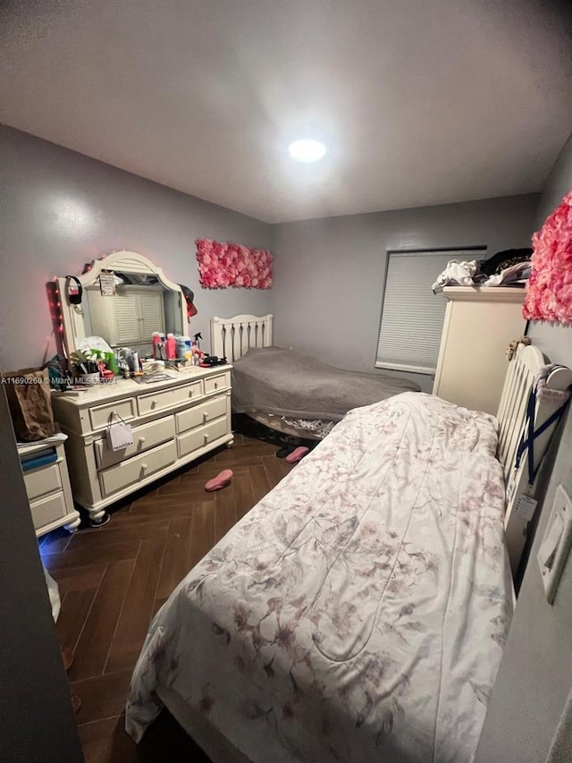 bedroom featuring dark parquet floors