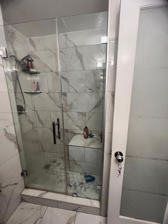 bathroom with a shower with door