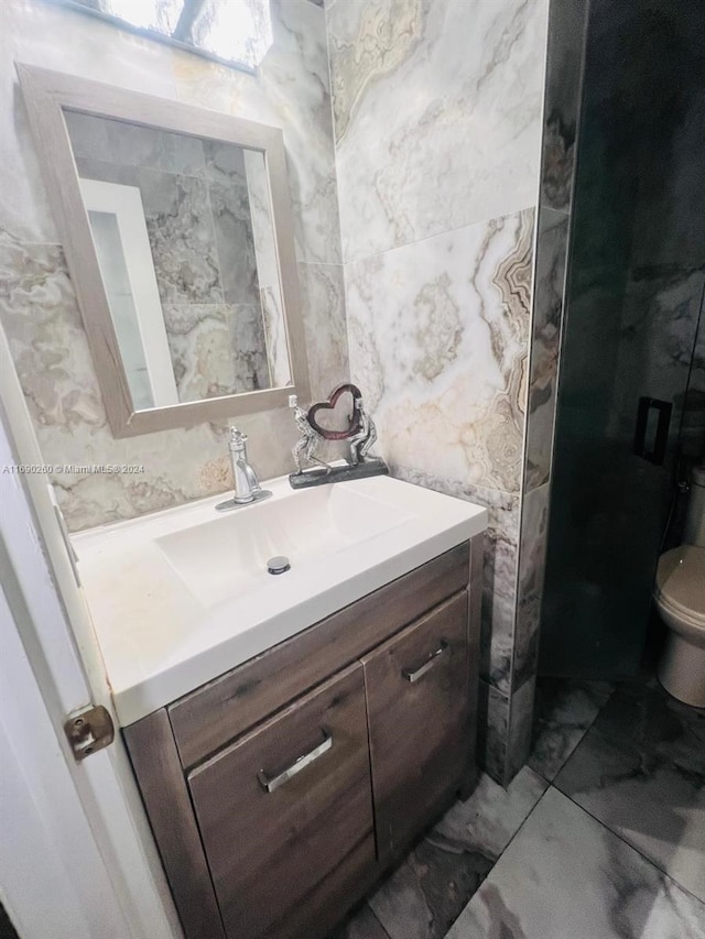 bathroom featuring vanity and toilet