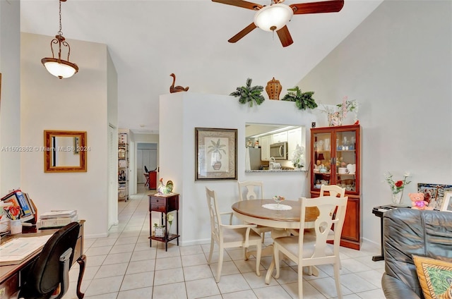 tiled dining area featuring ceiling fan and high vaulted ceiling