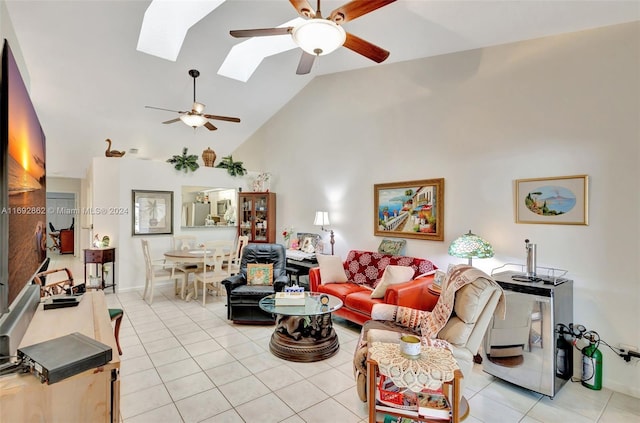 living room with high vaulted ceiling, light tile patterned floors, a skylight, and ceiling fan