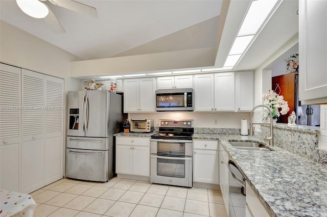 kitchen featuring white cabinets, sink, light tile patterned floors, and stainless steel appliances