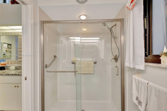 bathroom with an enclosed shower and vanity