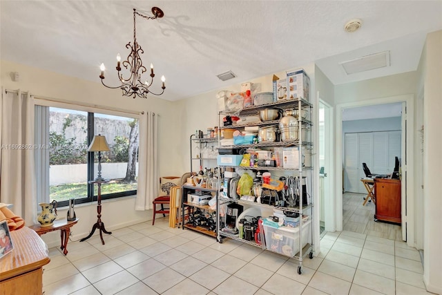 interior space featuring a textured ceiling, an inviting chandelier, and light tile patterned floors