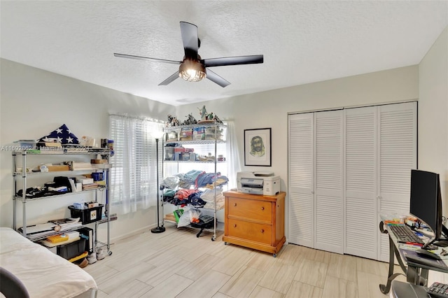 office with ceiling fan and a textured ceiling