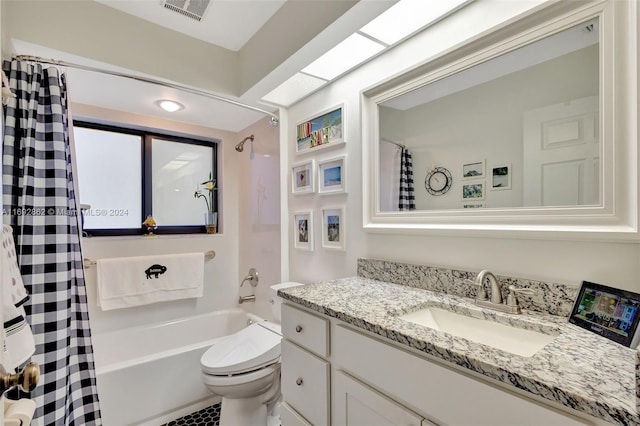 full bathroom featuring toilet, vanity, and shower / bathtub combination with curtain