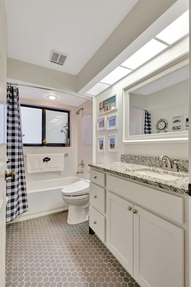 full bathroom featuring toilet, vanity, tile patterned flooring, and shower / bathtub combination with curtain