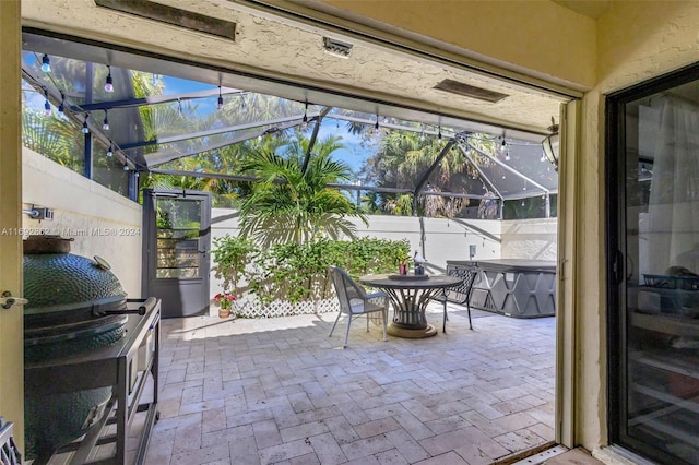 view of patio with glass enclosure and grilling area