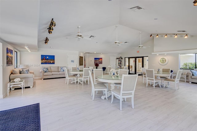 dining area featuring lofted ceiling, ceiling fan, and light hardwood / wood-style flooring