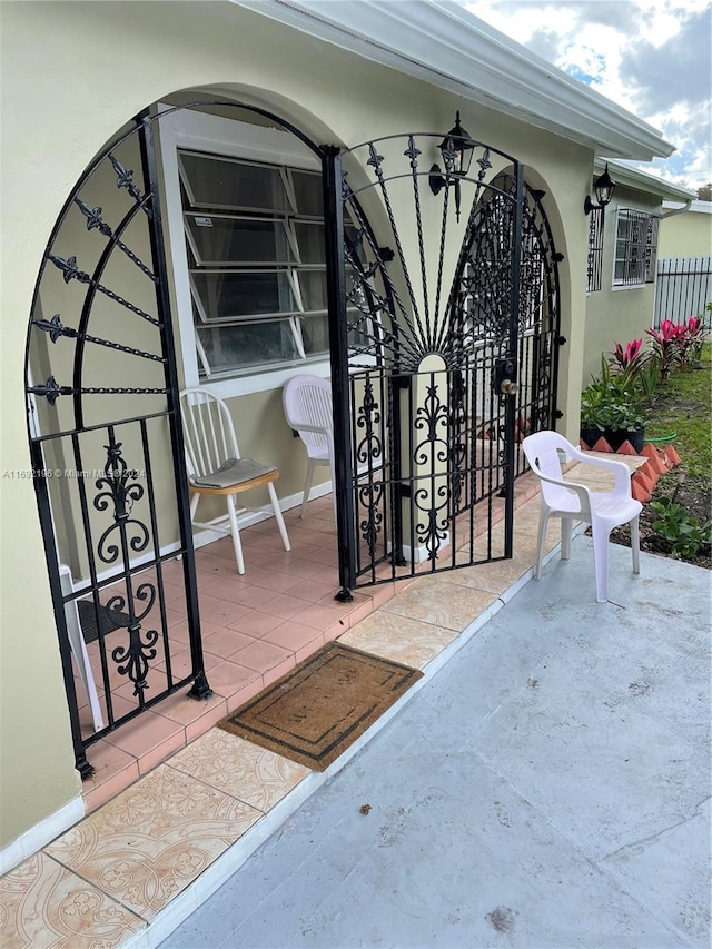 view of gate featuring a patio