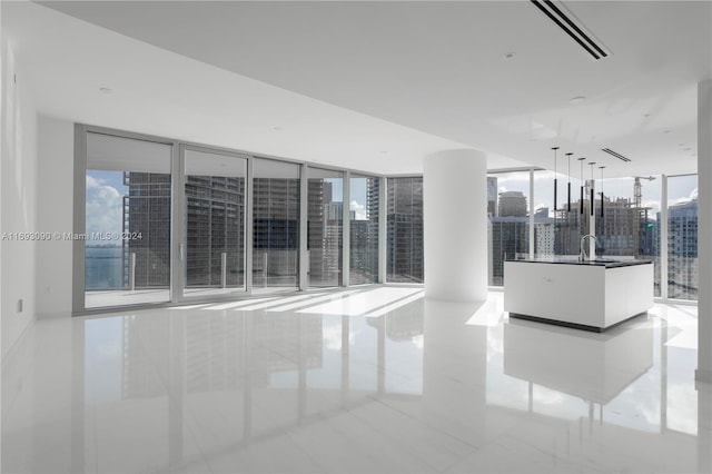 tiled spare room with floor to ceiling windows