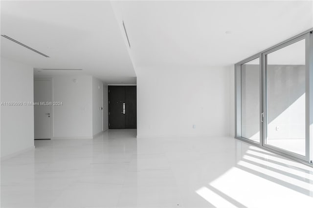 unfurnished room with expansive windows