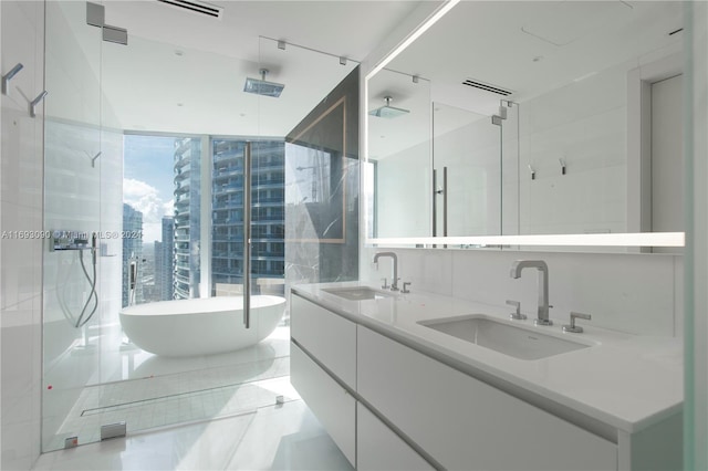 bathroom with tile patterned floors, vanity, and separate shower and tub