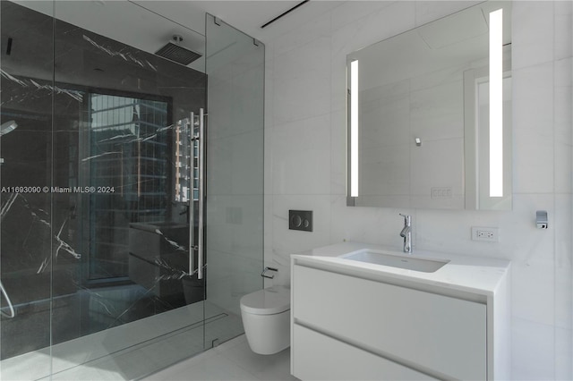 bathroom featuring a tile shower, vanity, tile walls, and toilet