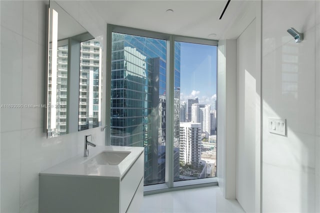 bathroom featuring vanity and floor to ceiling windows