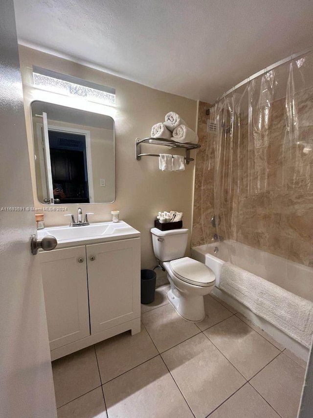 full bathroom with shower / tub combo, tile patterned floors, vanity, a textured ceiling, and toilet