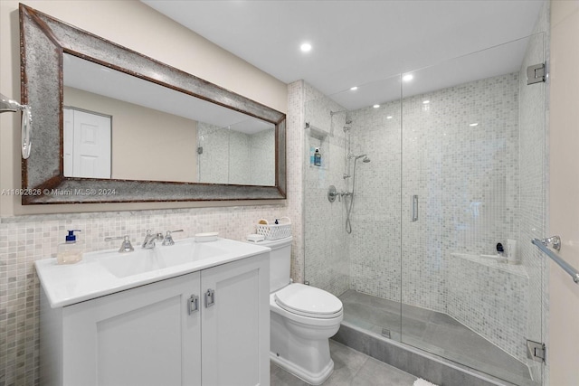 bathroom with walk in shower, vanity, tile walls, tile patterned flooring, and toilet