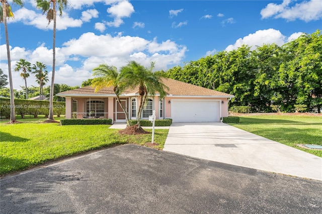 view of front of property featuring a garage and a front lawn