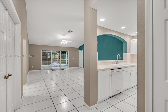 kitchen featuring light tile patterned flooring, white cabinets, white dishwasher, and sink