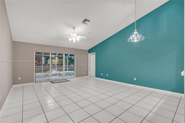 spare room with light tile patterned flooring, ceiling fan with notable chandelier, and high vaulted ceiling