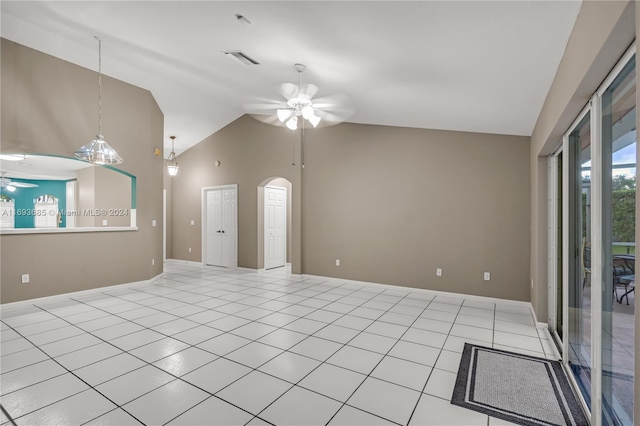 spare room featuring ceiling fan, lofted ceiling, and light tile patterned floors