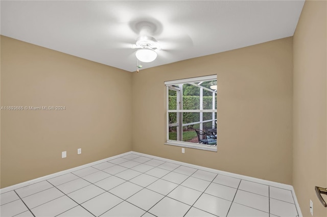 empty room with ceiling fan and light tile patterned floors