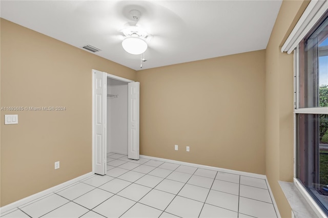 unfurnished bedroom with ceiling fan and light tile patterned floors