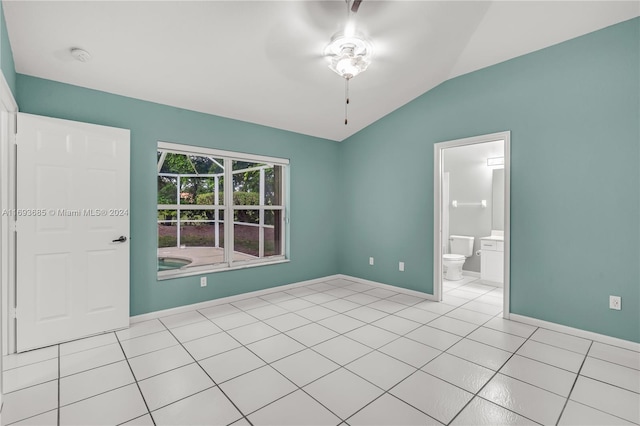 spare room with vaulted ceiling, ceiling fan, and light tile patterned flooring