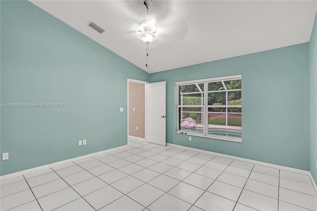 unfurnished room featuring ceiling fan, lofted ceiling, and light tile patterned floors