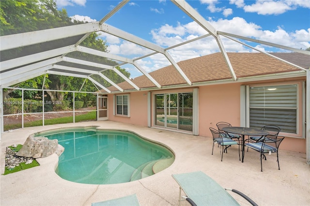 view of swimming pool featuring a lanai and a patio