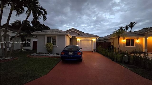 view of front of home with a front lawn and a garage