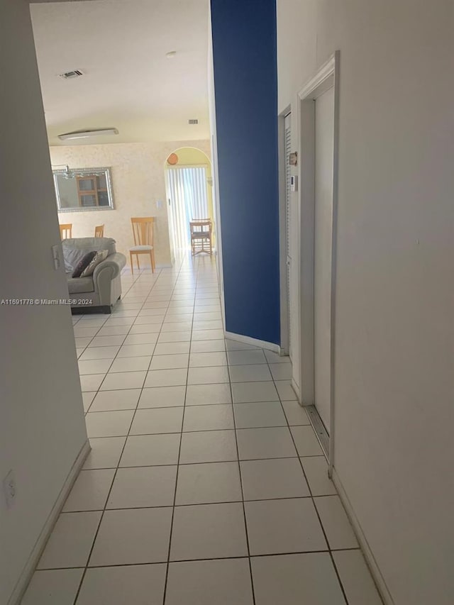 hall featuring light tile patterned floors