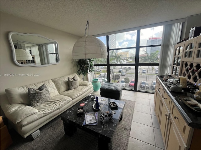 tiled living room with a textured ceiling and expansive windows