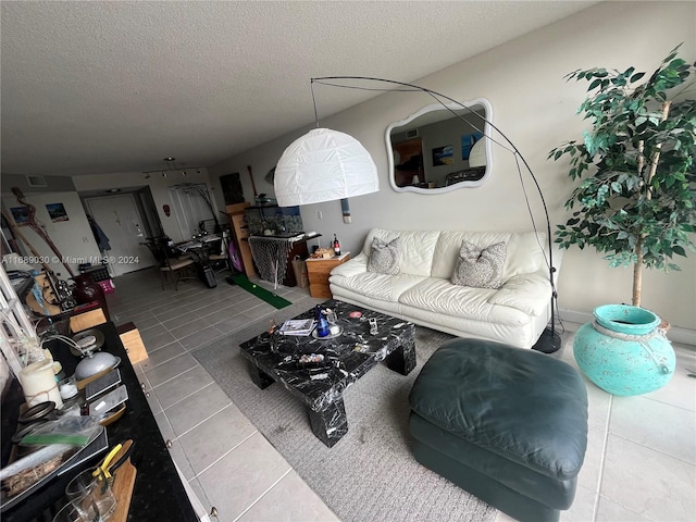 living room featuring tile patterned floors and a textured ceiling