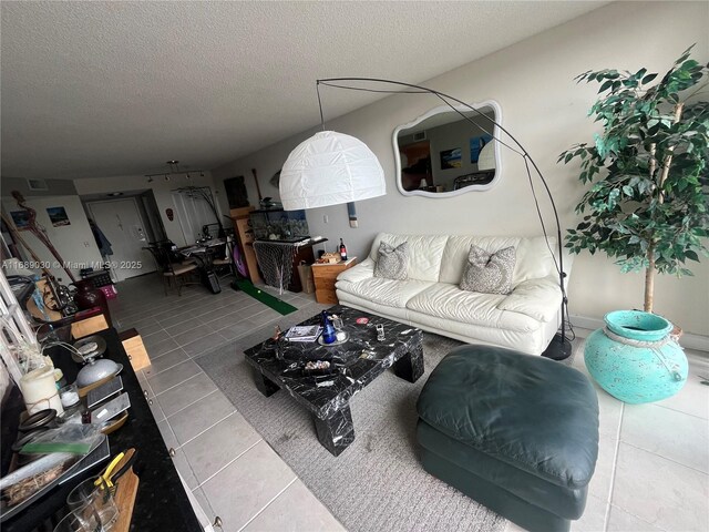 tiled living room featuring a textured ceiling